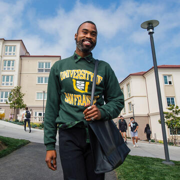 Student walks in front of Lone Mountain East dorm.