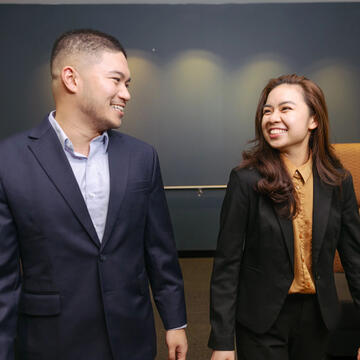 Two USF students in business attire chatting