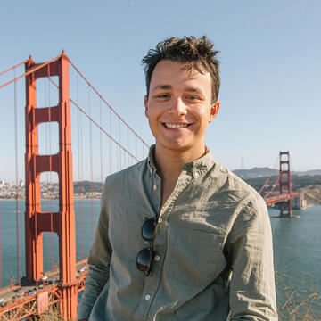 USF student poses in front of the golden gate bridge