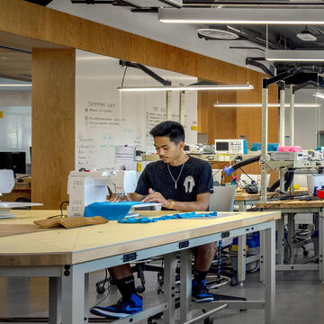 Student working at sewing machine in USF's Innovation Hive