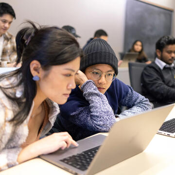 USF students working on their laptops in class