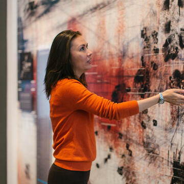 Shabnam Shermatova looking at a piece of art