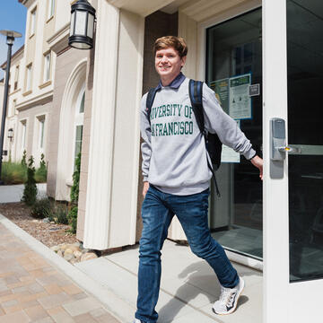 Student exiting a dorm building