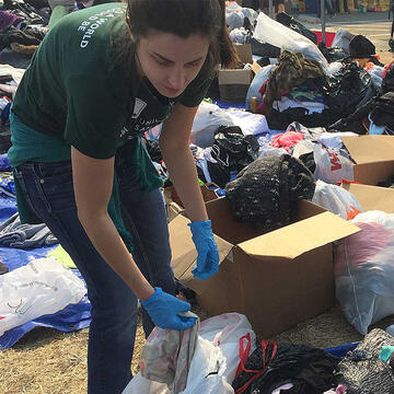 Student helps sort clothing donations for disaster victims.
