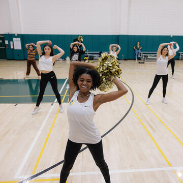 usf cheerleader holds pom pom in the air