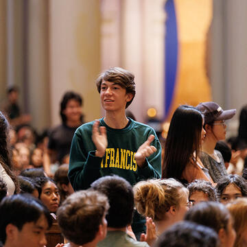 student clapping during convocation