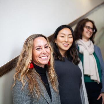 usf faculty smiling along stairwell