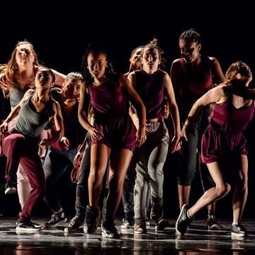 a group of students dancing on stage