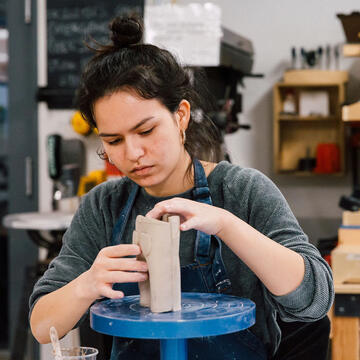 USF student working with clay