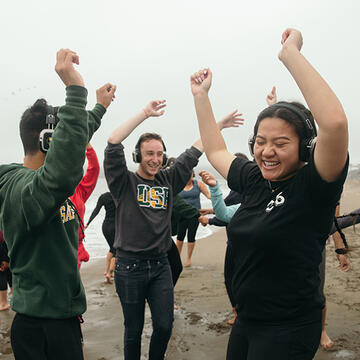 students listening to music at baker beach