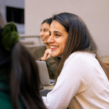 student smiling with others outside