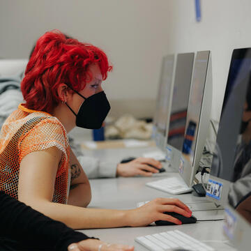 USF student working on an Apple iMac computer