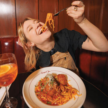 Student eats spaghetti at Original Joe's in SF