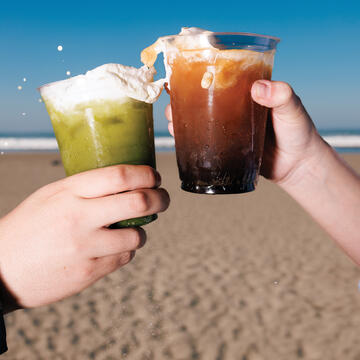 2 students cheers their drinks