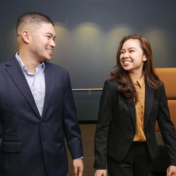 Two USF students chatting and walking on campus