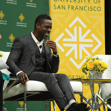 Stephanie D. Sears, Sterling K. Brown and Dr. Clarence B. Jones speak onstage.