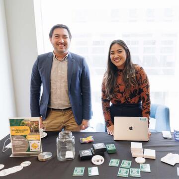 Two students tabling an event