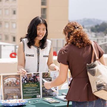 Student talking at a table