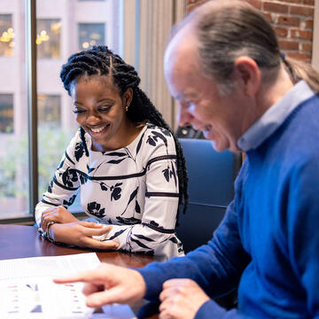 Student at a table with a professor