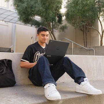 ryan lopez uses laptop outside