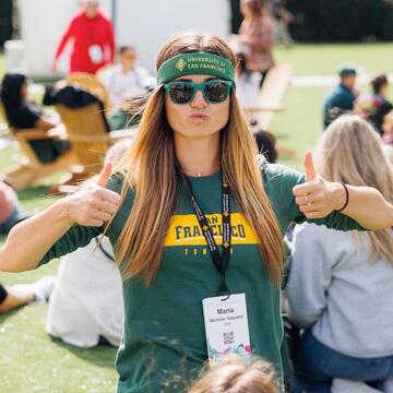USF alumni giving a thumbs up
