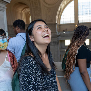student smiling inside the Beaux-Arts monument 