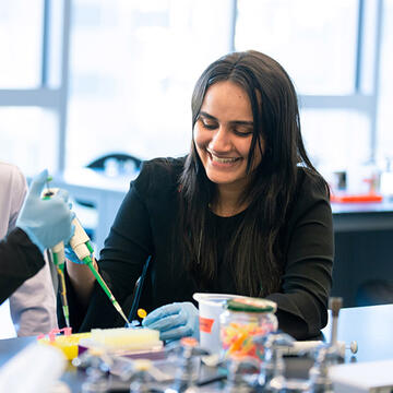 Biotech student smiling in class.