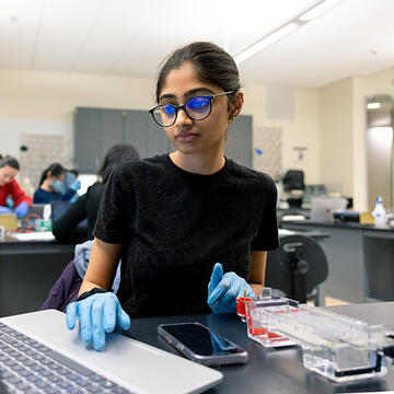 Biotech student on laptop.