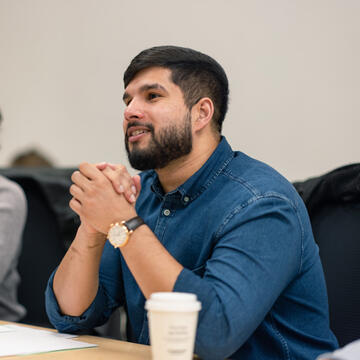 student crosses hands in class