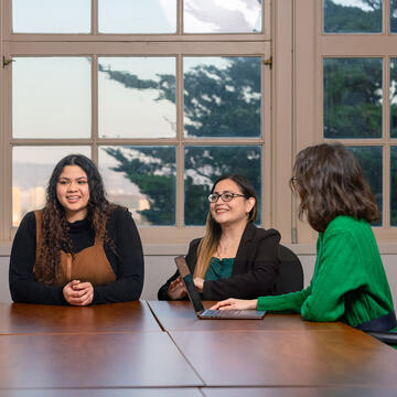 students sit together around table