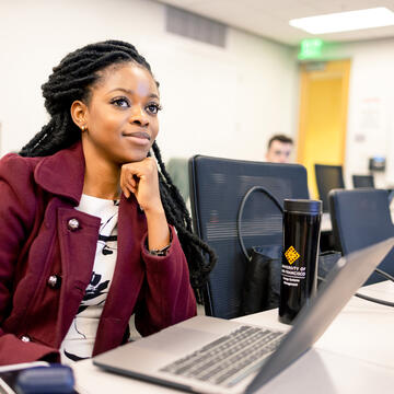 student sitting at table in class