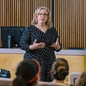 professor speaks to students in front of class