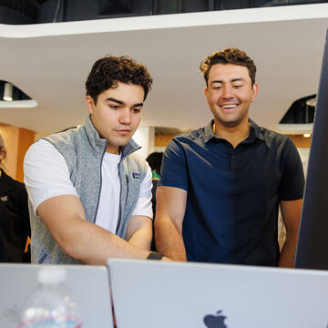 Students working on laptop.