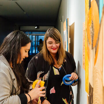 two students install exhibit