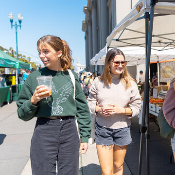 two students walking around the ferry market