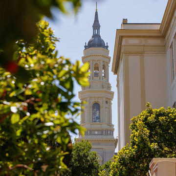 Campus building with cathedral spire in the background