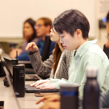 Student in class working on laptop