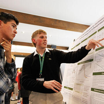 Two students presenting at a competition