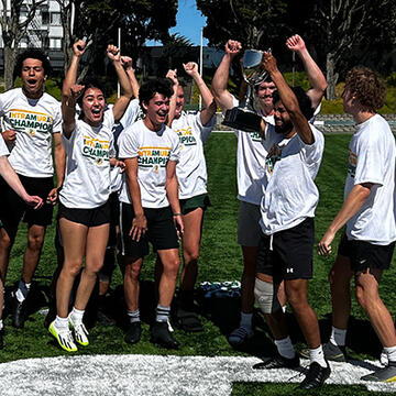 students jump into the air on a sports field