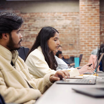 Student working on laptop in class