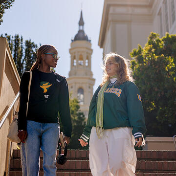 Two students walking with st. ignatius cathedral in background
