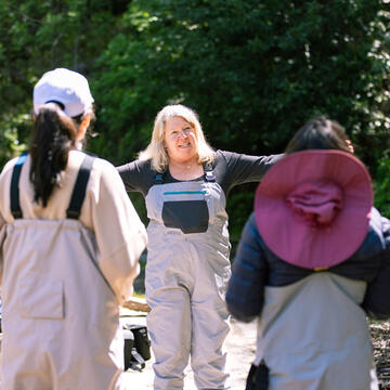 professor gestures to students outside
