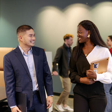 Two students smiling.