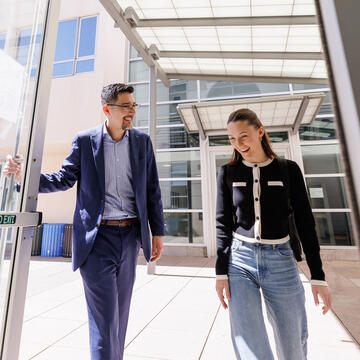 Professor holding door open for student