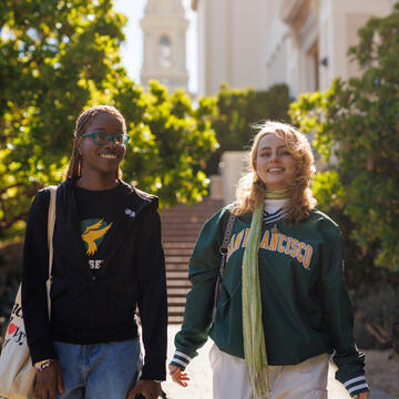 two students walk outside on usf campus