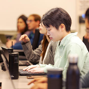Student in class working on laptop