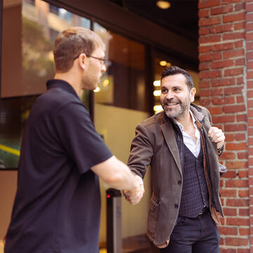 School of Management students shaking hands