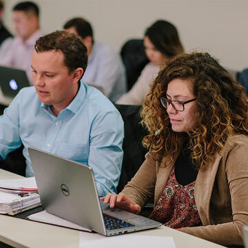 Students working on laptops in class
