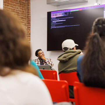 students look at code in front of room
