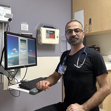 Doctor sitting in a chair in front of a screen